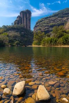 Rock formations lining the nine bend river or Jiuxi in Wuyishan Stock Photos