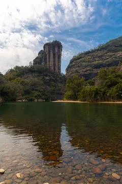 Rock formations lining the nine bend river or Jiuxi in Wuyishan Stock Photos