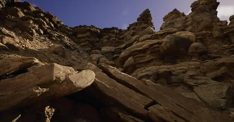 Rock formations rise dramatically under a clear sky in a natural landscape 스톡 일러스트