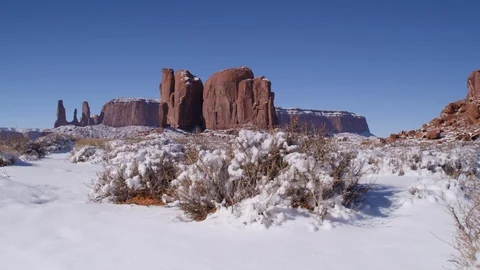 Rock formations surrounded with snow in Monument Valley area Stock Footage 104113540
