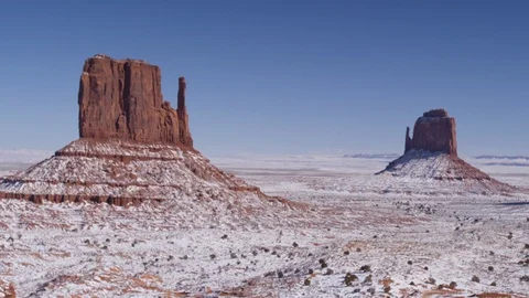 Rock formations surrounded with snow in Monument Valley area Stock Footage 104113704