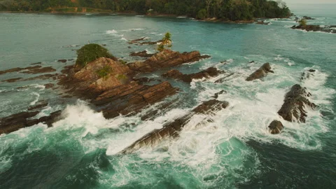 Rock formations in turquoise ocean waters off Dominicalito beach in Costa Rica Stock Footage 344773779