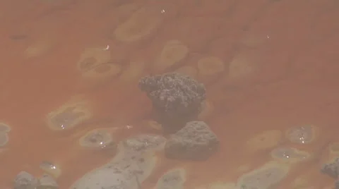 Rock forming within geothermal lake Stock Footage 3018171
