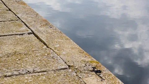 Rock Ground And Cloudy Sky Reflected In The Water Stock-Footage 125702716