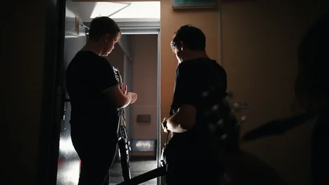 A rock group walking out on the stage and greeting their listeners - talking in Stock Footage 113819905