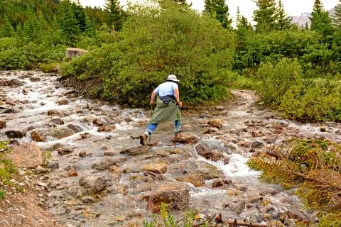 Rock hopping on a mountain stream Stockfoto's