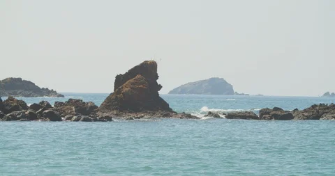 Rock jutting up from the ocean Stock Footage 108599643