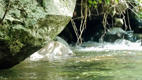 A rock is in the middle of a stream Stock Photos