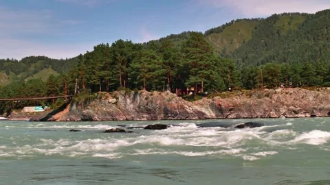 A rock in the middle of a wild river 動画素材 249504417