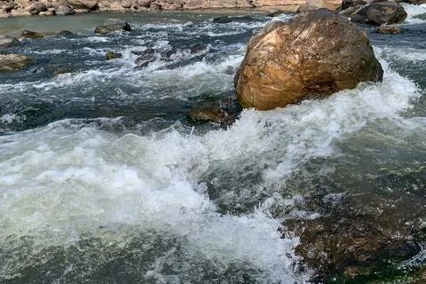 Rock in the midle of the river Stock Photos