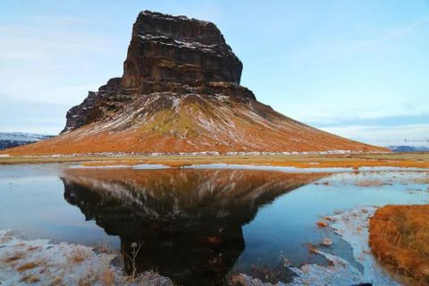 A rock mountain in the South Coast of Iceland, with reflection on a pond in e Stock Photos