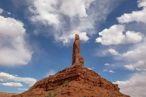 Rock needle with clouds Stock Photos