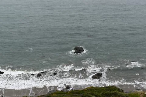 Rock in the Ocean waves Stock Photos