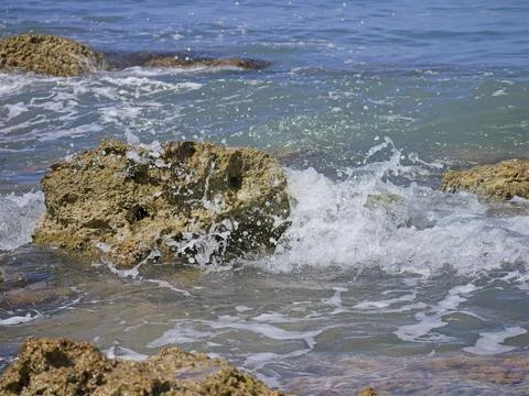 Rock in ocean waves Stock Photos