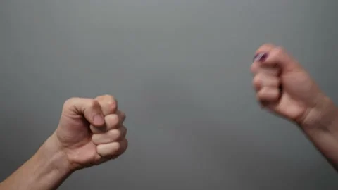 Rock paper scissors being played by young man and woman. Stock Footage 236256883