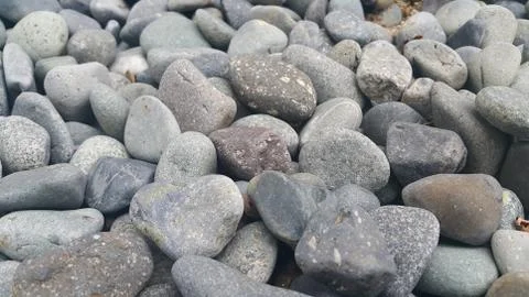 Rock Pebbles, small, rounded, smooth rocks. Texture background for text. Foto stock