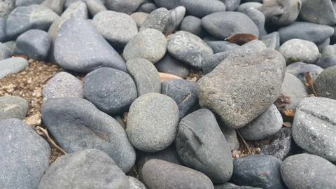 Rock Pebbles, small, rounded, smooth rocks. Texture background for text. Foto stock