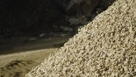 Rock pieces falling on heap slow motion, stone crushing machine in quarry work Video stock 294065515