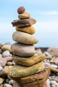 A rock pile or stack, with a blue sky as a background Stock Photos