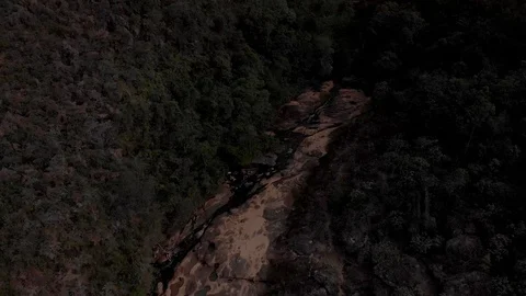 Rock plateau river bed with stream of a river cascading and forming ponds. Stock Footage 125872416