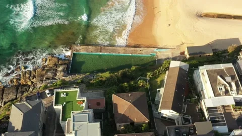 Rock pool and sandy Manly beach in aerial top down flying over houses 4k. Stock Footage 170792868