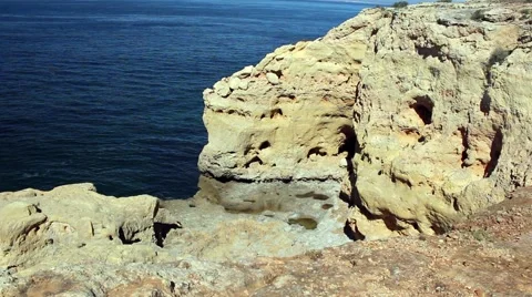 Rock pools a the bottom of steep cliffs Stock Footage 65015692