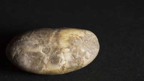 Rock rotating on a black background Stock Footage 117340476