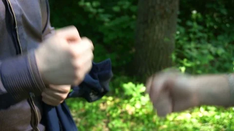 Rock, scissors, paper is played by two young man in the forest, high definition Stock Footage 77150698