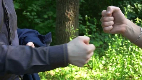 Rock, scissors, paper is played by two young man in the forest, high definition Stock Footage 77151124