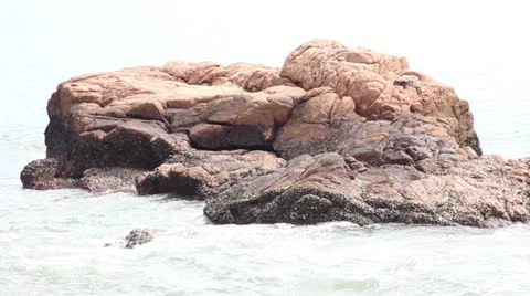 A rock in the sea Stock Footage 24703916