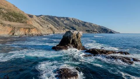Rock Sea Stack Surrounded by Waves on California Coast Stock Photos
