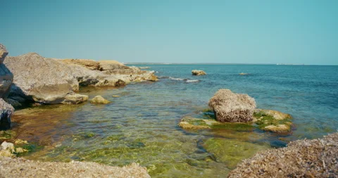 Rock on Seashore Gentle waves and Transparent Water of Mediterranean Sea 4k Stock Footage 343611855