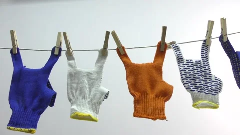 The rock sign is shown by work gloves that hang on a clothesline. Stock Footage 153894780