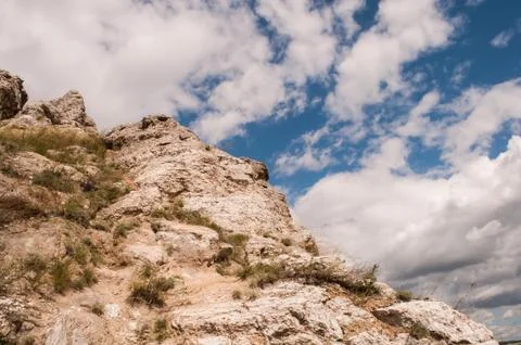 Rock on sky background with clouds. mountain background Stock Photos