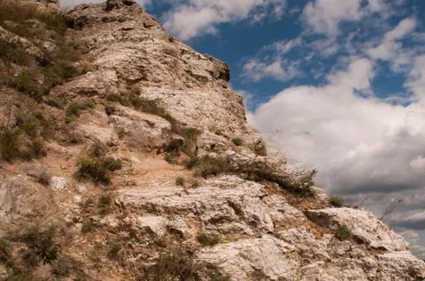 Rock on sky background with clouds. mountain background Stock Photos