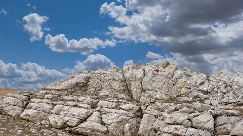 Rock in a sky background time lapse scene Stock Footage 306755501