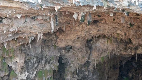 Rock soil layers line cave wall with stalactites - Mineral Strata and Well Stone Stock Footage 339813954
