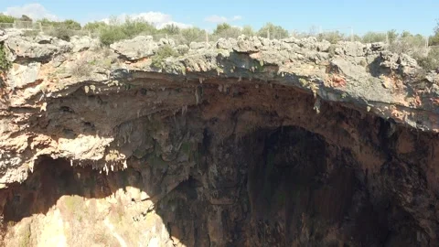 Rock soil layers line cave wall with stalactites - Strata Types and Fall Decline Stock Footage 339813971