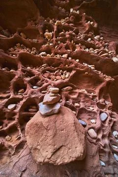 Rock Stack Cairn on Textured Red Sandstone Wall with Embedded Pebbles Stock Photos