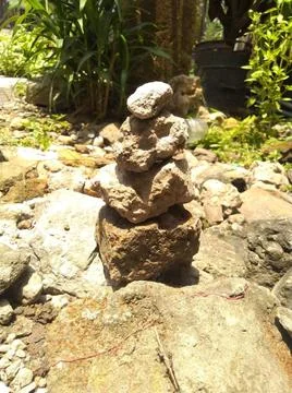 Rock Stack or Stone Balancing in the Garden Stock Photos