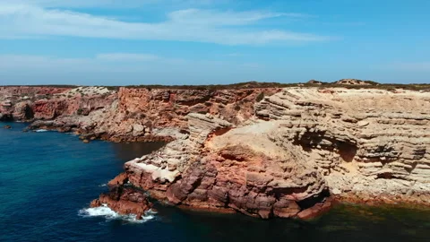 Rock strata overlooking ocean, stratified sandstone precipice with seascape and Video stock 321454562