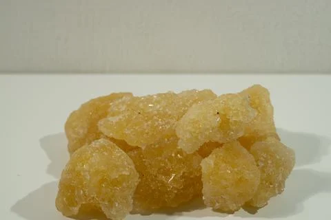 Rock sugar, in the form of irregular lumps and in smoother Stock Photos