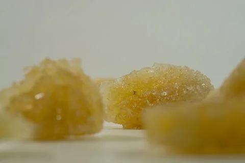 Rock sugar, in the form of irregular lumps and in smoother Stock Photos