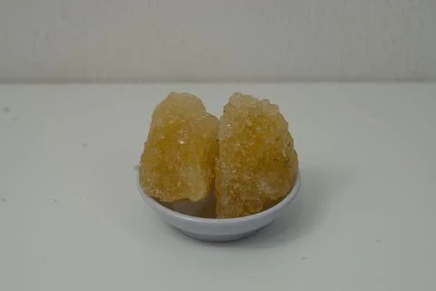 Rock sugar, in the form of irregular lumps and in smoother Stock Photos