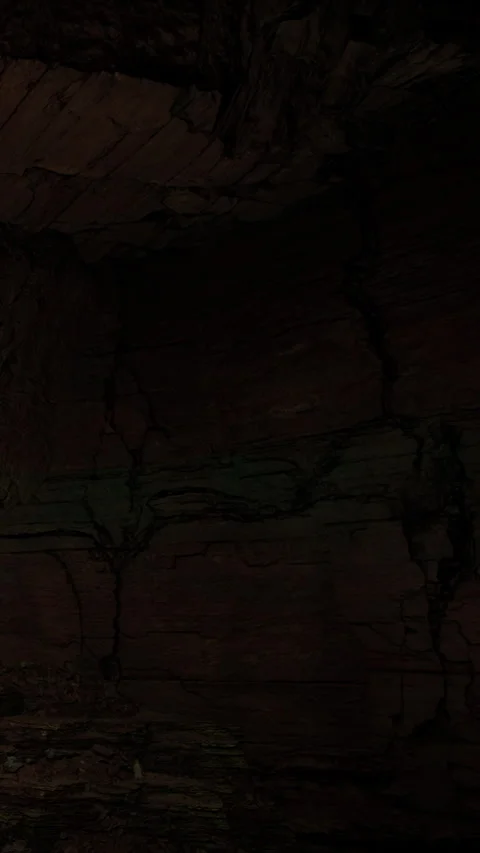 Rock surface with cracks showing texture and color under dim light Stock Footage 340876930