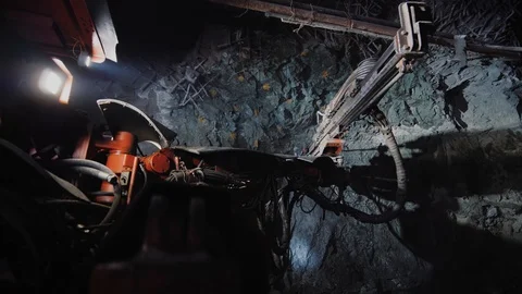 Rock surface drilling machine used to drill blast holes at mine tunnel Stock Footage 121750291