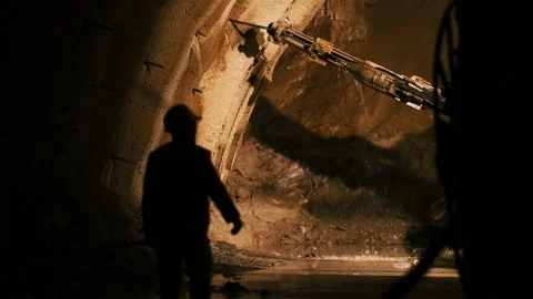 Rock surface drilling machine used to drill blast holes at tunnel construction Stock Footage 204102388