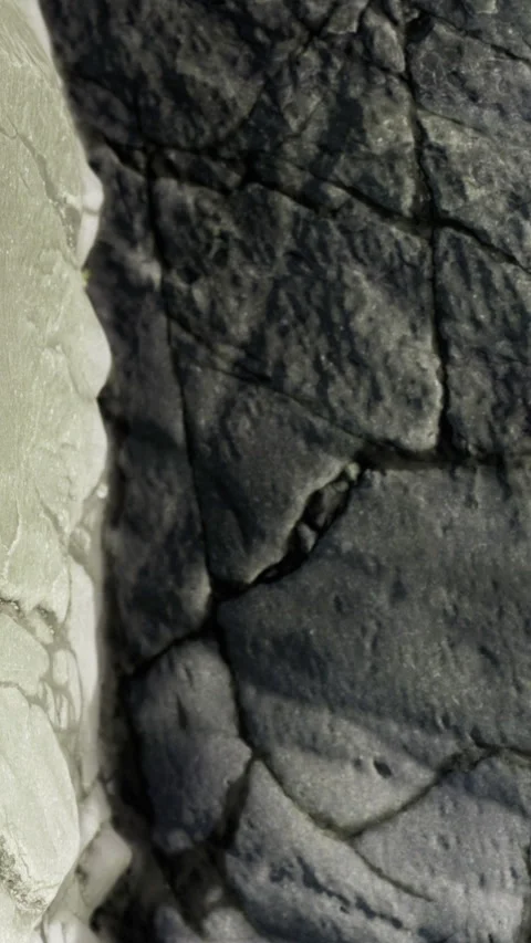 Rock surface shows texture and color differences in natural setting Stock Footage 333566149