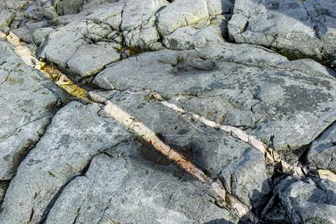 Rock texture and surface background. Cracked and weathered natural stone back Stock Photos