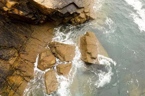 Rock textures and waves in a cliff in Galicia, Spain Stock Photos